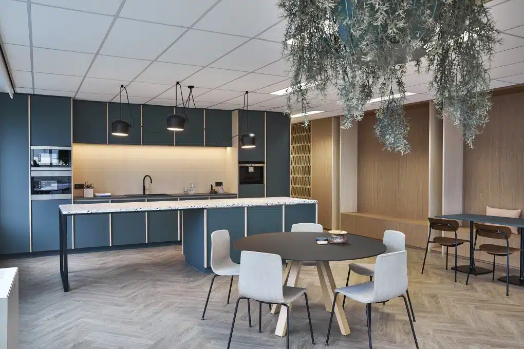 Espace de travail flexible et convivial avec cuisine et coin salon pour des discussions informelles et des pauses